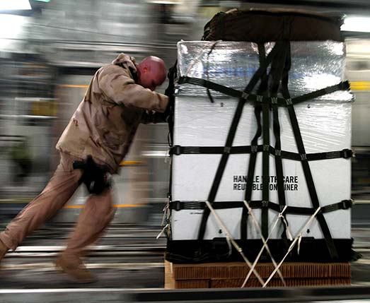 man pushing a shipping crate